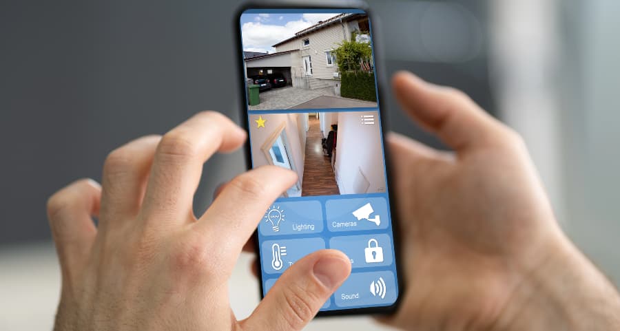 Homeowner looking at video camera streams on a cell phone